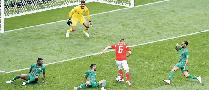  ??  ?? Russia’s Denis Cheryshev dribbles past Saudi Arabia players to score his side’s second goal during the 2018 FIFA World Cup opening match at the Luzhniki stadium in Moscow, Russia, yesterday.