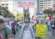  ?? RALPH BARRERA / AMERICAN-STATESMAN ?? Kate Corgill carries her niece Kinley Witt, 5, as they join Kinley’s mother Cassidy Witt (left) on Saturday in the Women’s March on Austin, which may have drawn as many as 50,000 people.