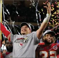  ?? (AP/David J. Phillip) ?? Quarterbac­k Patrick Mahomes (left) and defensive back Tyrann Mathieu celebrate after the Kansas City Chiefs beat the San Francisco 49ers in Super Bowl XIV in February. More teams each year will have the chance to celebrate a Super Bowl title after NFL owners approved an expanded playoff format Tuesday.