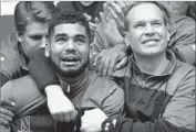  ?? David Banks Getty Images ?? CHRIS COLLINS, right, who coached the Wildcats to NCAA tournament, with player Sanjay Lumpkin.