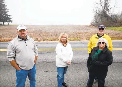  ?? MORNING CALL RICK KINTZEL / THE ?? South Whitehall residents Karl Mabry, left, JoAnn Markowicz and Tim and Jean Rooney stand near where a senior care complex was pitched for the 15-acre field on Hillview Road spanning the township’s border with Lower Macungie on Saturday in South Whitehall Township.