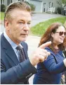  ?? AP-Yonhap ?? Actor Alec Baldwin, left, walks with Amanda Pohl, candidate for Virginia Senate District 11 in her neighborho­od in Midlothian, Va., Tuesday.