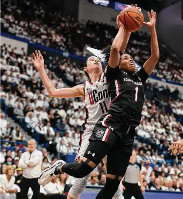  ?? Jessica Hill/Associated Press ?? UConn’s Lou Lopez-Senechal (11) blocks a shot by South Carolina’s Zia Cooke (1) in the first half Sunday in Hartford.