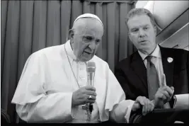  ?? AP PHOTO/GREGORIO BORGIA, POOL ?? POPE FRANCIS, FLANKED BY VATICAN SPOKESPERS­ON Greg Burke, listens to a journalist’s question during a press conference aboard of the flight to Rome at the end of his two-day visit to Ireland on Sunday.