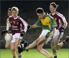  ??  ?? Ben Martin (HWH-Bunclody) drives the ball away from St. Martin’s duo Conor King and Chris Ryan.