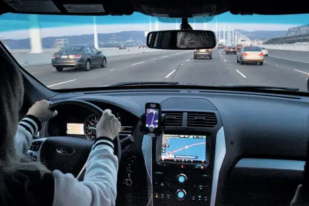  ?? Leah Millis / The Chronicle ?? Erin Kennedy drives a passenger over the Bay Bridge to Berkeley. The El Cerrito resident has been working for Lyft for two years, and also does work for Sidecar and UberX. She says she has never felt unsafe with passengers.