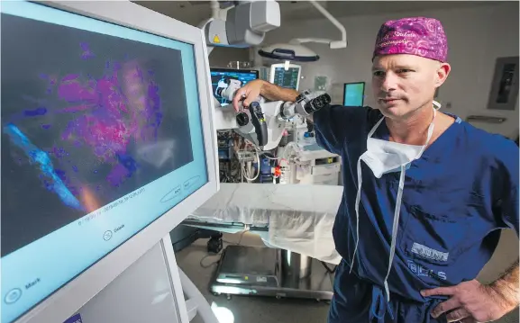  ?? PHOTOS: WAYNE CUDDINGTON ?? Dr. John Sinclair has been trained in a new brain surgery technique, used for first time in Canada, that makes tumours glow in fluorescen­t pink and orange.