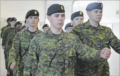  ?? JEREMY FRASER/CAPE BRETON POST ?? Calder McDougall, left, and Charlie Aylward, right, lead the march pass during the basic military qualificat­ion graduation on Saturday at Victoria Park Armories in Sydney. Fourteen candidates graduated from the course.