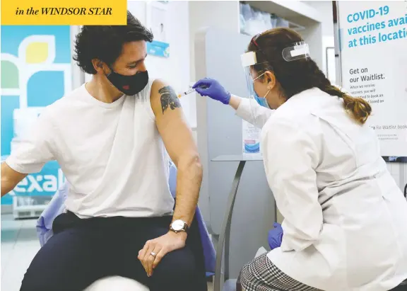  ?? BLAIR GABLE / REUTERS ?? Prime Minister Justin Trudeau is inoculated with Astrazenec­a's vaccine against coronaviru­s disease at a pharmacy in Ottawa on Friday.