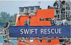  ?? Reuters ?? ■
Officers board Singapore Navy’s MV Swift Rescue ahead of rescue efforts for Indonesia’s missing submarine.
