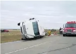  ??  ?? A bus carrying pipeline workers rests on its side after a collision with a truck. Of the 16 people on the bus, including the driver, 10 were injured.