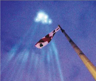  ?? PHIL CARPENTER FILES ?? Fourteen beams of light shoot skyward at the Mont Royal Chalet on Dec. 6, 2014, part of a day of commemorat­ions marking the 25th anniversar­y of the murder of 14 women at École Polytechni­que. The spectre of gun violence casts a long shadow over this city, Allison Hanes writes.