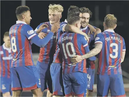  ??  ?? 2 Aaron Doran (No 10) is congratula­ted by his Inverness Caley Thistle team-mates after scoring what proved to be the winner against Dundee United at the Caledonian Stadium last night.