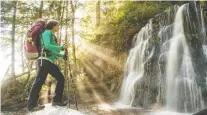  ?? SCOTT MUNN ?? A hiker takes in the picturesqu­e waterfall at Bonilla Creek on the West Coast Trail. The hike is challengin­g and diverse.