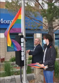 ??  ?? Swift Current Mayor Denis Perrault raises the Pride Flag while Southwest Saskatchew­an Pride Board Chair Braden Forbes looks on, June 29.