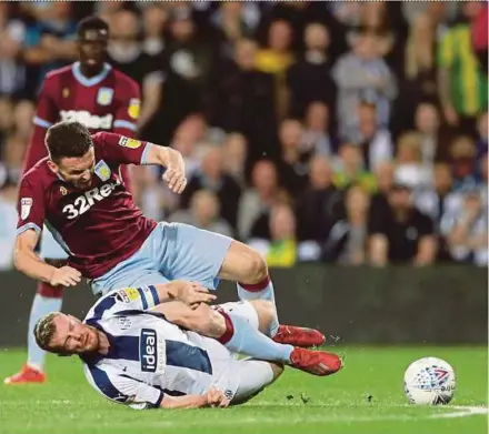  ?? REUTERS PIC ?? West Bromwich Albion’s Chris Brunt (bottom) challenges Aston Villa’s John McGinn in their Championsh­ip playoff semi-finals on Tuesday.