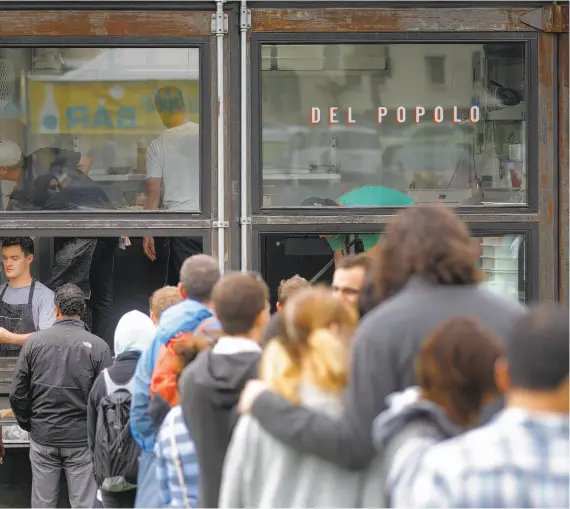  ??  ?? People line up at the Del Popolo Pizza food truck, above, during Off the Grid’s Sunday Picnic at the Presidio in San Francisco.