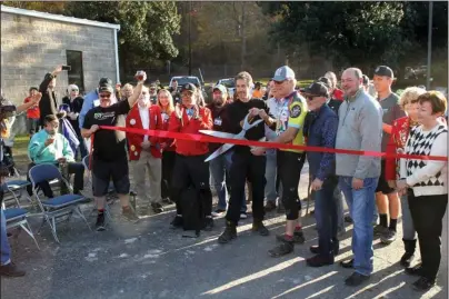  ?? The Sentinel-Record/Richard Rasmussen ?? TRAIL OPEN: Mayor Pat McCabe and The Walton Foundation Program Director Gary Vernon officially opened the Northwoods Trail system by cutting a ribbon at a ceremony Friday.