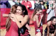  ?? NWA Democrat-Gazette/DAVID GOTTSCHALK ?? University of Arkansas cross country runner Taylor Werner receives a hug from a teammate at the finish Friday during the NCAA South Regional at the Agri Park course in Fayettevil­le. Werner won the overall individual title and the Razorback women won the overall team title.