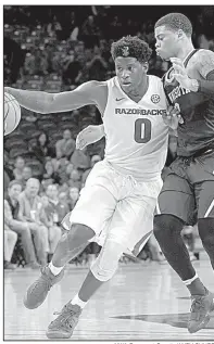  ?? NWA Democrat-Gazette/ANDY SHUPE ?? Guard Jaylen Barford drives to the basket against Minnesota guard Nate Mason on Saturday during the Razorbacks’ 95-79 victory over the No. 14 Golden Gophers at Walton Arena in Fayettevil­le. Barford led the Razorbacks with 22 points on 9-of-15 shooting...