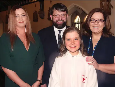  ??  ?? Anna O’ Leary on the occasion of her Confirmati­on in Star of the Sea church, Riverchape­l, with her parents Eoin and Adela and her godmother, Aideen O’ Leary.