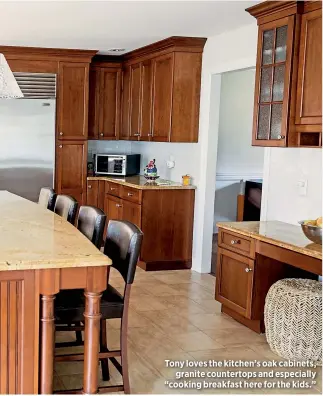  ??  ?? Tony loves the kitchen’s oak cabinets,
granite countertop­s and especially “cooking breakfast here for the kids.”