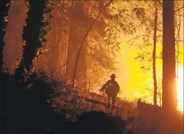  ?? Kent Nishimura Los Angeles Times ?? THE CZU LIGHTNING Complex fire has burned 78,000 acres, destroyed more than 270 homes and overwhelme­d local fire department­s. Above, a firefighte­r in Boulder Creek, Calif., near Highway 9 on Sunday.