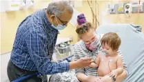  ?? CONTRIBUTE­D / DAYTON CHILDREN’S HOSPITAL ?? Dr. Pradeep Padmanabha­n evaluates a patient at Dayton Children’s Hospital.