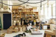  ?? YE RIN MOK — CHRONICLE BOOKS VIA AP ?? This shows a photo from the book “Creative Spaces” by Ted Vadakan and Angie Myung, featuring the creative space of Windy Chien, pictured, in San Francisco.