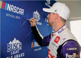  ?? Meg Oliphant/Getty Images ?? Denny Hamlin, who won the pole for the Ally 400 at Nashville Superspeed­way, will wear a “cool suit” to combat the high temperatur­es during Sunday’s race.