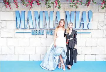  ?? — Reuters photos ?? Lilly James and Amanda Seyfried attend the world premiere of Mamma Mia! Here We Go Again at the Apollo in Hammersmit­h, London, Britain Monday. • (Below) Behind her, Lily’s scholarly co-stars were seen throwing their mortar board hats in the air while...