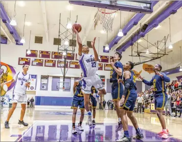  ?? Cory Rubin/The Signal (See additional photos on signalscv.com) ?? Valencia senior forward Jayden Trower goes up for the layup in a playoff matchup with Santa Monica at Valencia High School on Tuesday night. The Vikings won 52-40 and will play Temecula in the next round of playoffs.