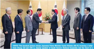  ?? ?? TOKYO: This handout picture shows Japanese Prime Minister Fumio Kishida (4th R) receiving a letter from Chung Jin-suk (4th L), deputy speaker of South Korea’s National Assembly and the head of a delegation sent by South Korean President-elect Yoon Suk-yeol to Japan, at the prime minister’s office in Tokyo. —AFP