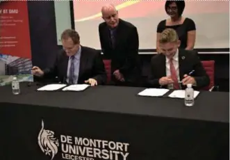  ??  ?? Pacific University of Technology and Innovation (APU) Vice-Chancellor Professor Ron Edwards (seated, left) exchanging the partnershi­p agreement with De Montfort University (DMU) Pro Vice-Chancellor for Strategic and Internatio­nal Partnershi­ps James Gardner (seated, right). With them are Professor Dr APU Quality Assurance and Partnershi­ps dean Andy Seddon (standing, left) and DMU Faculty of Technology associate dean (internatio­nal) Elizabeth Hathaway.