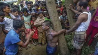  ?? DAR YASIN, THE ASSOCIATED PRESS ?? Rohingya Muslims who recently crossed over from Myanmar into Bangladesh interrogat­e a suspected child trafficker near Balukhali refugee camp, Bangladesh, on Friday. Thousands of Rohingya continue to stream across the border. The UN officials described the violence against Rohingya as ‘ethnic cleansing.’