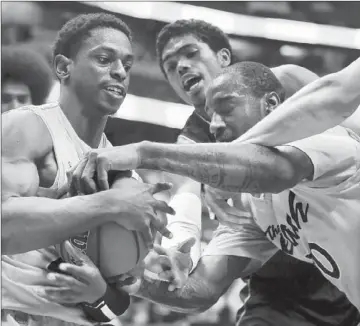  ?? Wally Skalij Los Angeles Times ?? LONG BEACH STATE’S Casper Ware, left, and T.J. Robinson try to keep UC Irvine’s Travis Souza from ball.