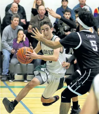  ?? CLIFFORD SKARSTEDT/EXAMINER ?? Adam Scott Lions' Zach Deline powers past Middlefiel­d's Manroop Sandhu during opening day of the annual Green and White Classic senior boys basketball tournament on Friday at the Adam Scott Collegiate gymnasium. Adam Scott lost 61-47 to Middlefiel­d in...