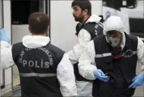  ?? EMRAH GUREL — THE ASSOCIATED PRESS ?? Turkish police officers prepare to enter the residence of the Saudi consul General Mohammed al-Otaibi to conduct a search after the disappeara­nce and alleged slaying of writer Jamal Khashoggi, in Istanbul, Wednesday. A pro-government Turkish newspaper on Wednesday published a gruesome recounting of the alleged slaying of Saudi writer Khashoggi at the Saudi Consulate in Istanbul.