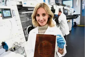  ?? — aFP ?? Malinkiewi­cz poses with a printed solar panel at her company Saule in Wroclaw.