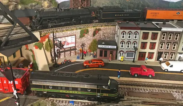  ??  ?? 4 You should be able to identify Len’s favorite railroad after looking at the road names on the MTH steam engine on the upper level and the MTH F7 diesel entering town below. Still stumped? Check out the brand of beer advertised on the billboard!