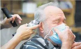  ?? Photo / AP ?? Barber shops are among businesses reopening in some US areas.