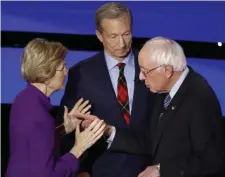  ?? AP FILE ?? GETTING BERNED: After this exchange at the end of the Democratic presidenti­al primary debate in Des Moines, Iowa, on Jan. 14, in which Democratic presidenti­al candidate Sen. Elizabeth Warren reportedly refused to shake hands with Sen. Bernie Sanders, I-Vt., right, her poll numbers dropped. Looking on is candidate Tom Steyer.