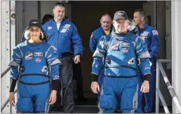  ?? FRANK MICHEAUX / NASA VIA AP ?? NASA’s Boeing Crew Flight Test astronauts Suni Williams and Butch Wilmore exit the Neil A. Armstrong Operations and Checkout Building April 26 at the agency’s Kennedy Space Center in Florida during a mission dress rehearsal.