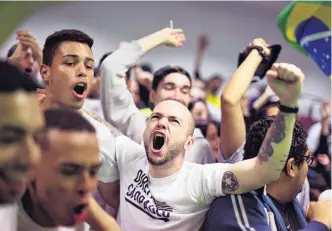  ?? PHOTO: REUTERS ?? Supporters of Jair Bolsonaro react to Bolsonaro winning 46% of the vote in the in first round of the Brazilian presidenti­al election.