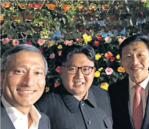  ??  ?? Kim Jong-un appears in his first ‘selfie’, taken by Vivian Balakrishn­an, the Singaporea­n foreign minister, left, alongside Ong Ye Kung, the city state’s education minister