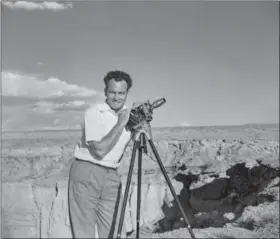 ?? AP PHOTO/ PEGGY GOLDWATER/COURTESY OF THE BARRY & PEGGY GOLDWATER FOUNDATION ?? In this photograph taken in 1935by Peggy Goldwater, entitled “Portrait of the Artist as a Married Man,” Barry Goldwater smiles and poses with his camera at Coal Mine Canyon between Tuba City and the Third Mesa in northeaste­rn Arizona. The late Sen. Barry Goldwater’s granddaugh­ter is working to preserve the thousands of images of Arizona landscapes and Native Americans that he created over his lifetime. Twenty years after the Republican icon’s death, Alison Goldwater Ross has formed a foundation to digitize and repair the images.