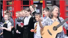  ??  ?? Singer-songwriter Christine Kydd with P7 pupils from Alyth Primary who sang one of the songs they had written and recorded