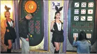  ??  ?? Participan­ts of a room escape game try to solve puzzles in Hangzhou, Zhejiang province.