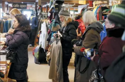  ?? STEPHANIE ZOLLSHAN — THE BERKSHIRE EAGLE VIA AP, FILE ?? Shoppers form a long line at checkout during Small Business Saturday at the Arcadian Shop in Lenox, Mass. Many small and independen­t retailers who are holding Small Business Saturday shopping events Thanksgivi­ng weekend are banding together with others, believing that there’s strength in numbers.