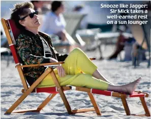  ?? ?? Snooze like Jagger: Sir Mick takes a well-earned rest on a sun lounger